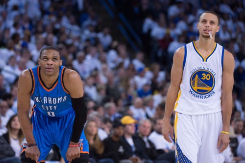 January 5, 2015; Oakland, CA, USA; Oklahoma City Thunder guard Russell Westbrook (0) and Golden State Warriors guard Stephen Curry (30) look on during the third quarter at Oracle Arena. The Warriors defeated the Thunder 117-91. Mandatory Credit: Kyle Terada-USA TODAY Sports